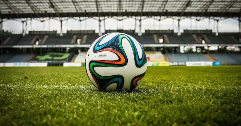 A football sits on a stadium pitch - this article covers concerns raised over the World Cup Pride march between Iran and Eygpt
