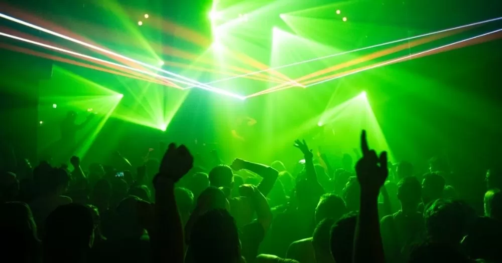 This article is about queer nightlife in Ireland. In the photo, a crowd dancing in a club with green lights.