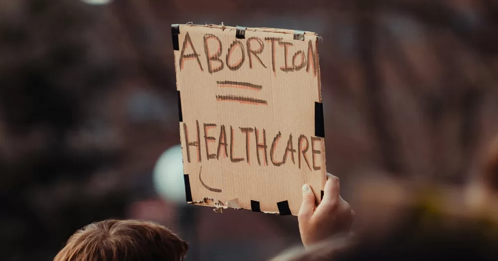 A protest sign reads "Abortion = Healthcare" The Dáil has narrowly voted not to restore an abortion bill.