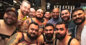 Members of Ireland's bear scene posing for a photo together, with several wearing harnesses.