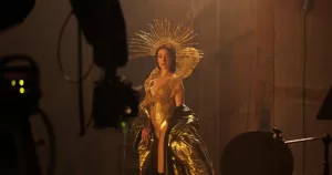 Screengrab from trailer for Mother Mary showing Anne Hathaway dressed in gold