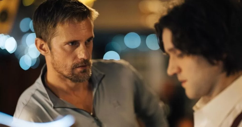 Screenshot of film Pillion, which has recently won several awards, where the two main actors are talking at a bar.