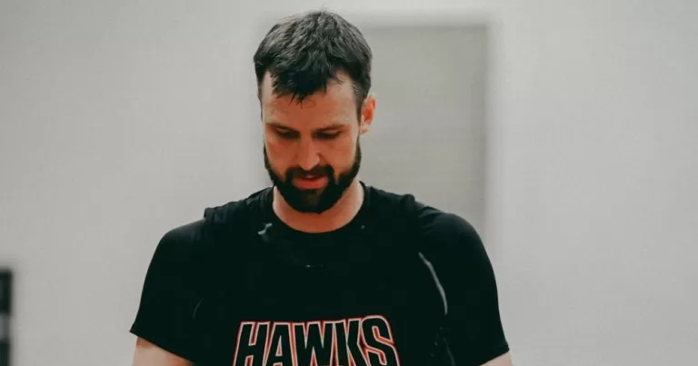 AJ Ogilvy wearing a black Hawks shirt