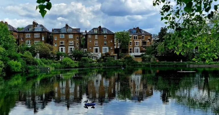 Hampstead Heath pond in London, with houses in the background.