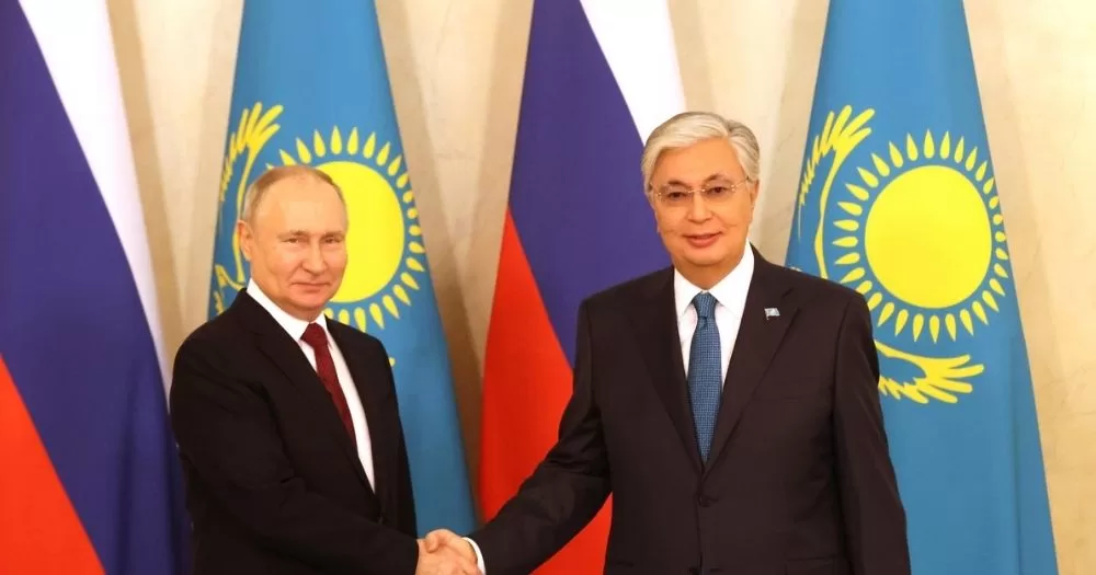 Russia's President Vladimir Putin and Kazakhstan's President Kassym-Jomart Tokayev shake hands. President Tokayev recently signed in a law targeting the LGBTQ+ community.