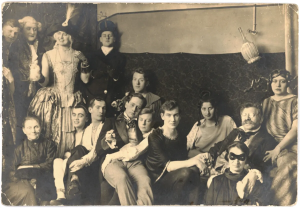 Costume party at the Institute for Sexual Research in Berlin, date and photographer unknown. Magnus Hirschfeld (in glasses) holds hands with his partner, Karl Gies. Image via SCIAM