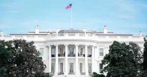 The white house with an american flag. This article covers reports stating the fall of global democracy and human rights