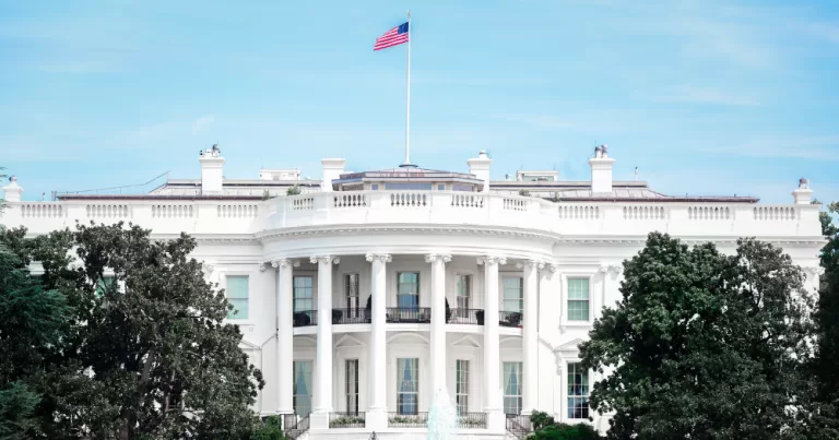 The white house with an american flag. This article covers reports stating the fall of global democracy and human rights