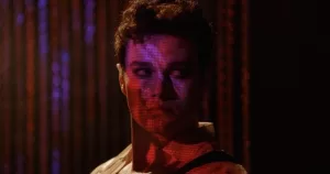 Chris Colfer in colourful light from the still of The Restoration at Grayson Manor which will premiere at DIFF.
