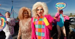 Drag queens walk with community members at The Outing Festival