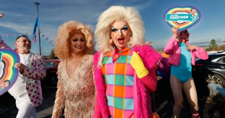 Drag queens walk with community members at The Outing Festival