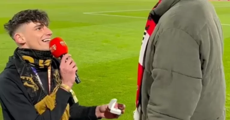 Image shows Pasca Kaiser on one knee, proposing to his partner.