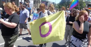 Protestors holding an intersex flag march in Serbia. This image is being used to accompany a story about a law banning unnecessary procedures on intersex children in Victoria, Australia.