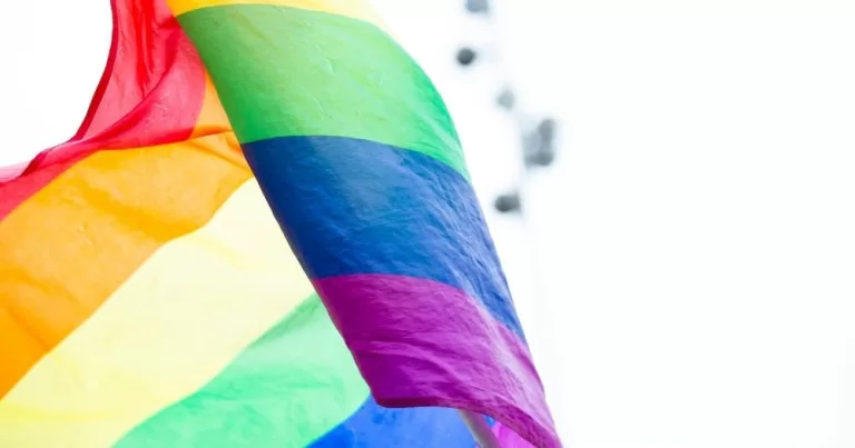 A pride flag blowing in the wind. This image is being used to represent the Government approving a scheme to disregard convictions for same-sex sexual activity.