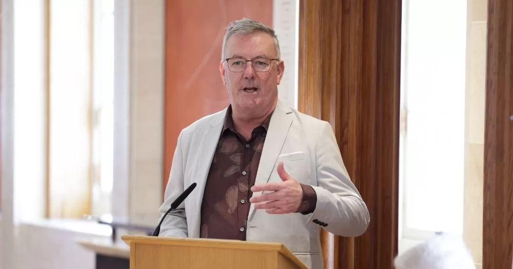Northern Ireland Health Minister Mike Nesbitt speaking on a podium.