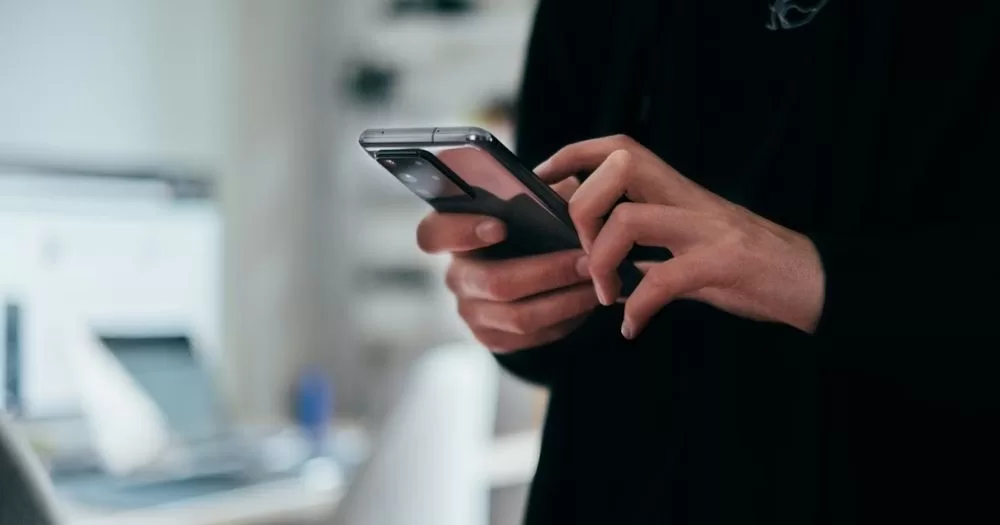 This article is about image-based sexual abuse. in the photo, a person holding a phone and typing.