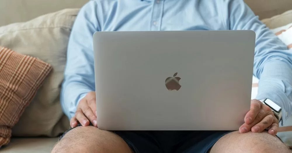 A person sits with a laptop on their knees. This image is being used to accompany an article about a new chemsex survey in Ireland.