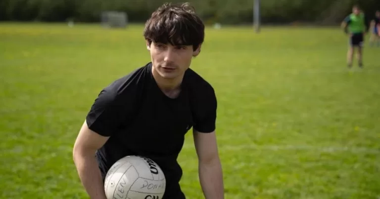 A Gaelic football player holds a ball on a pitch in a still from an upcoming short film.