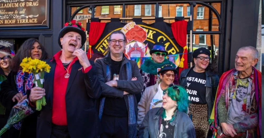 People stand outside The Black Cap.