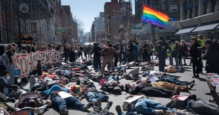 ACT UP members lay on the streets of New York as part of a die-in outside Palantir.