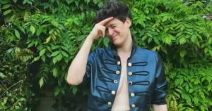 Rain Dove, a model who was recently the target of verbal abuse in Dublin, poses in front of some shrubs.