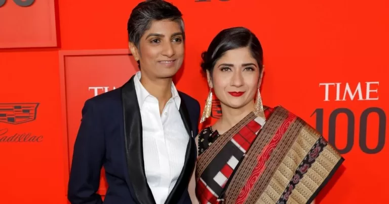 Photo of Menaka Guruswamy, who could beocme India's first LGBTQ+ member of parliament, and her partner posing for photos on the red carpet.