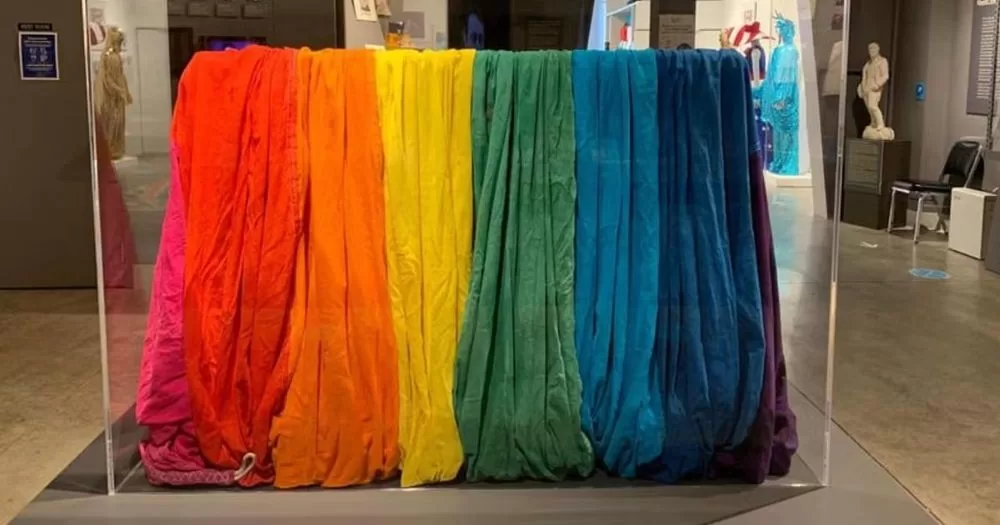 A fragment of the original pride flag sits in a glass case in San Francisco.