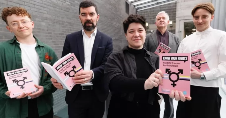 Members of rights groups holding the Know Your Rights guide for trans and non-binary people.