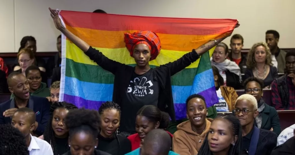 Activists in Botswana, where an anti-sodomy law was repealed, posing for a picture with one of them holding a Pride flag.
