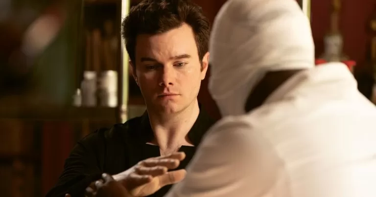 Chris Colfer in a scene of The Restoration at Grayson Manor, looking at his hand.