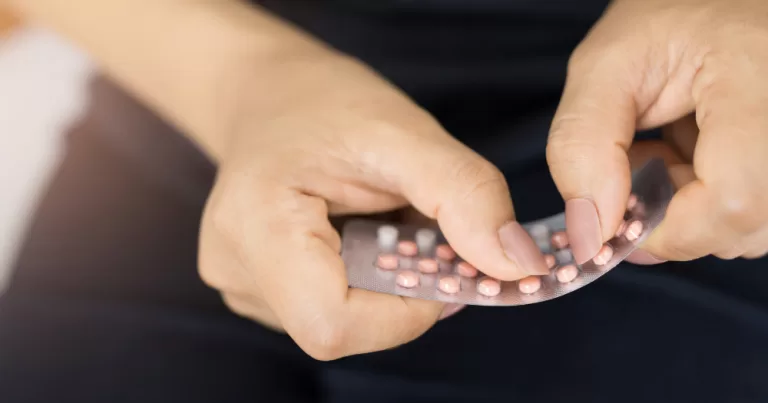 A person using a contraceptive pill. This article covers a report on the free contraception scheme.