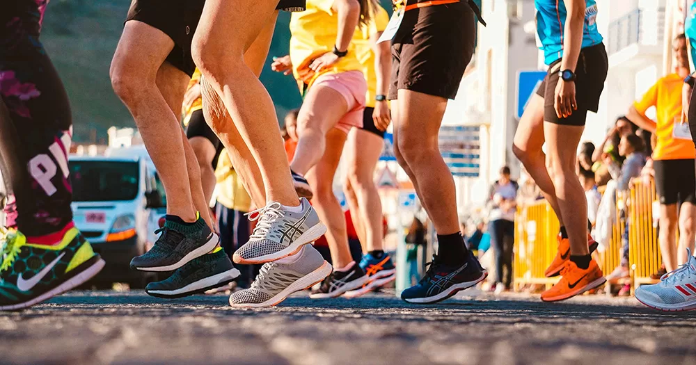 This article is about people running the Dublin Marathon for GCN. The image shows the legs of people preparing to run a race.