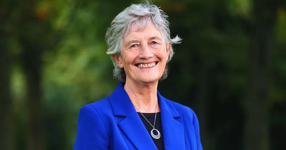 Irish President Catherine Connolly, who has become a patron of Belong To, smiling at the camera while wearing a bright blue blazer.