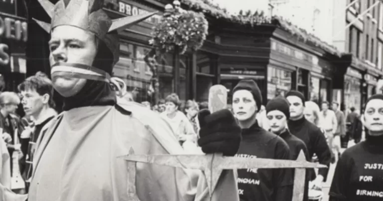 A black and white archival photo of The Diceman doing street art on Grafton Street.