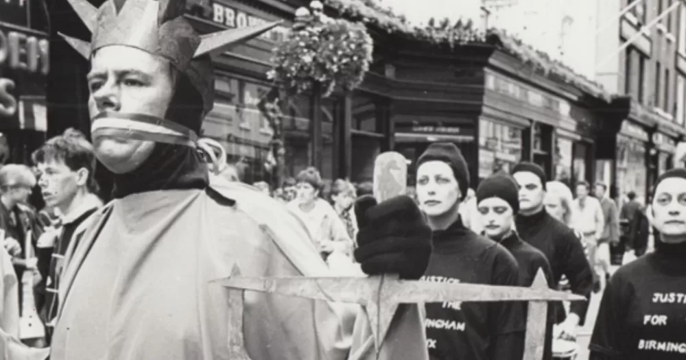 A black and white archival photo of The Diceman doing street art on Grafton Street.