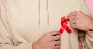 Red awareness ribbon on hoodie - this artcile covers HIV prevention.