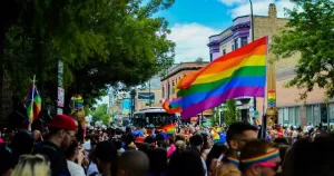 A pride march with flags in the air in solidarity.