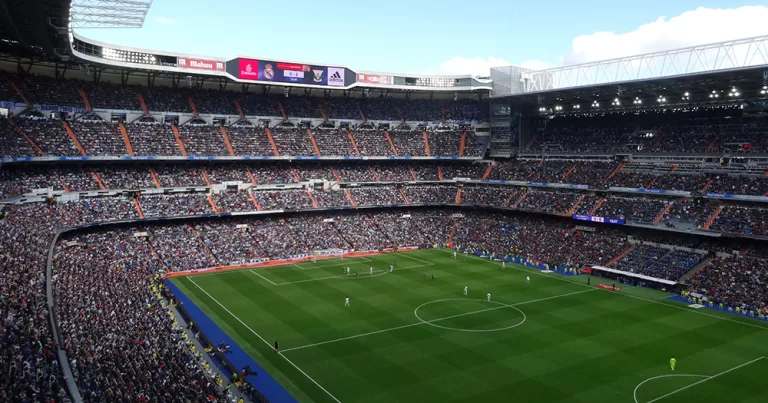 A wide angle image of Real Madrid's stadium with fans in the stands.