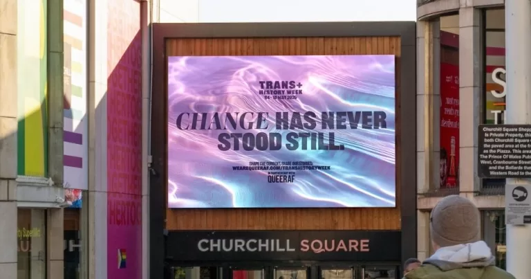 Image of a Trans+ History Week's campaign at Churchill Square. It shows a screen with water in the background, featuring the words "Change has never stood still".