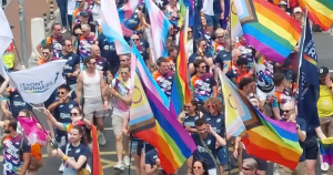 A crowd of marchers holding flags at the 2026 Dublin Pride parade.