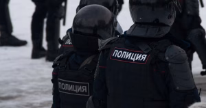 This article is about Russia jailing three people under the LGBT movement ban. In the photo, Russian police in uniform walking on the street.