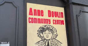 Poster about the Anne Devlin Community Centre, with a black and white portrait of the historical figure.
