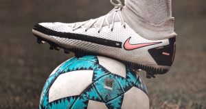 Image of a person's foot on top of a football