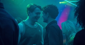Still of Nick and Charlie in a nightclub in the Heartstopper Forever film.
