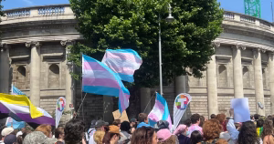 This article is about the clinical lead of the HSE gender healthcare. In the photo, people marching through Dublin carrying trans flags.