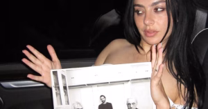Charli xcx holding a vinyl cover for her new album Music, Fashion, Film.