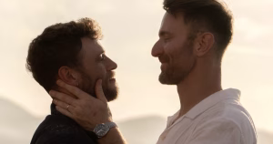 Olympian Gus Kenworthy and boyfriend Andrew Rigby as they are getting engaged, looking at each other tenderly.