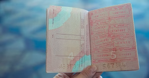 This article is about a same-sex couple being denied an Irish passport for their daughter. In the photo, a passport opened in a stamps page.