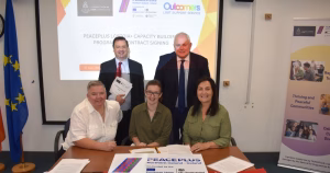 Five people behind the new LGBTQ+ PEACEPLUS project pose for a photo.