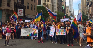 This article is about the Russian LGBT Network shutting down after being labelled an extremist organisation. In the photo, activists marching while holding Pride, Russian and Ukranian flags.